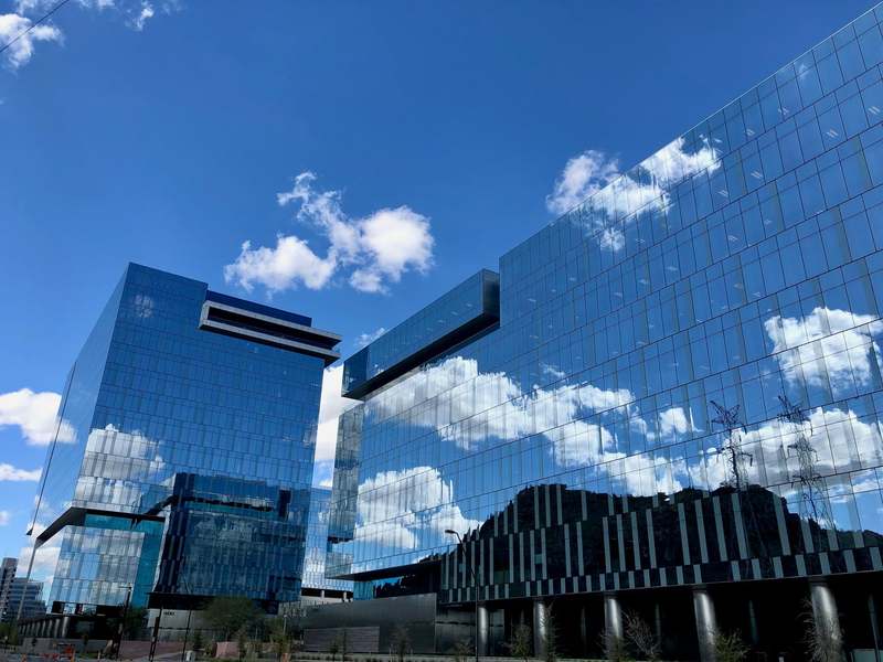 Glass office buildings reflecting blue sky and clouds in Tempe, Arizona